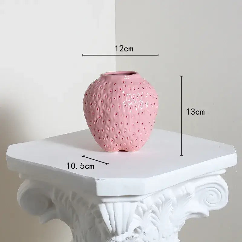 DecorBites™ strawberry cartoon ceramic vase in pink with textured surface and perforations for kids room decor