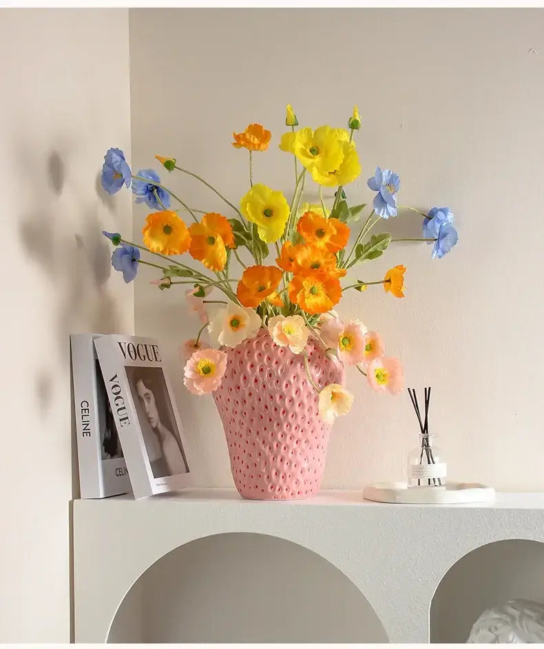 DecorBites™ strawberry cartoon flower vase pink ceramic with textured surface holding vibrant artificial poppies bouquet