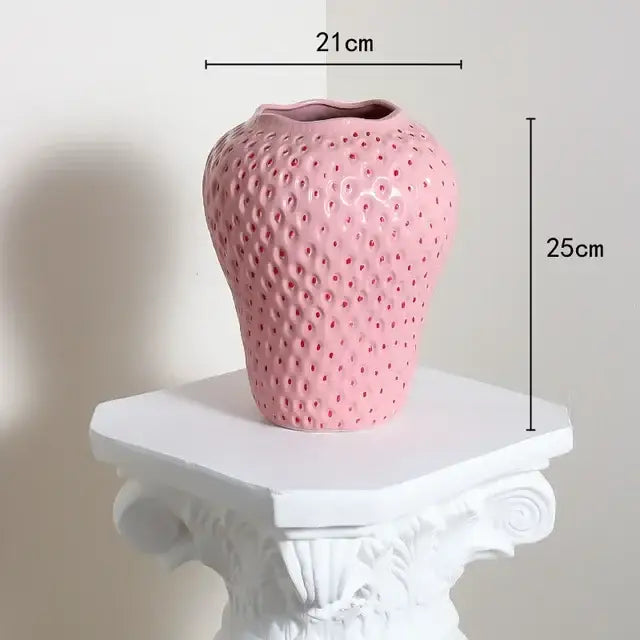 Pink ceramic flower vase shaped like a cartoon strawberry with textured surface and glossy finish for home décor