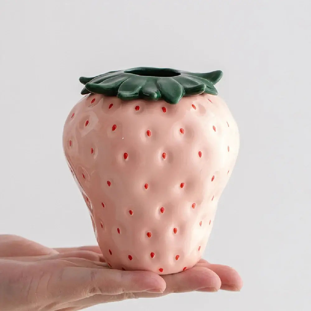 DecorBites™ strawberry shaped pink ceramic planter pot with red seed dots and green leafy top for indoor use