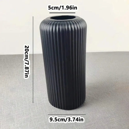 Black ribbed striped ceramic-like plastic vase by decorbites for flowers with a sleek modern design