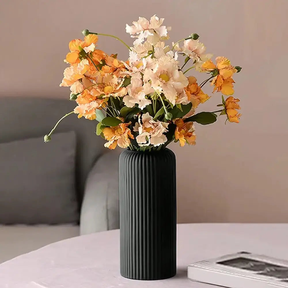 Decorbites™ striped ceramic-like plastic vase in black holding orange and cream artificial flowers bouquet