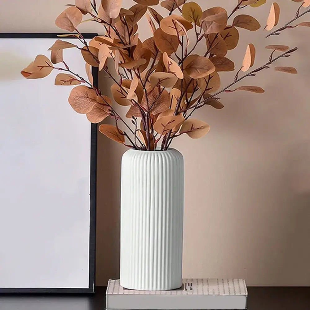 Decorbites™ striped ceramic-like plastic vase in white ribbed design holding dried brown eucalyptus branches