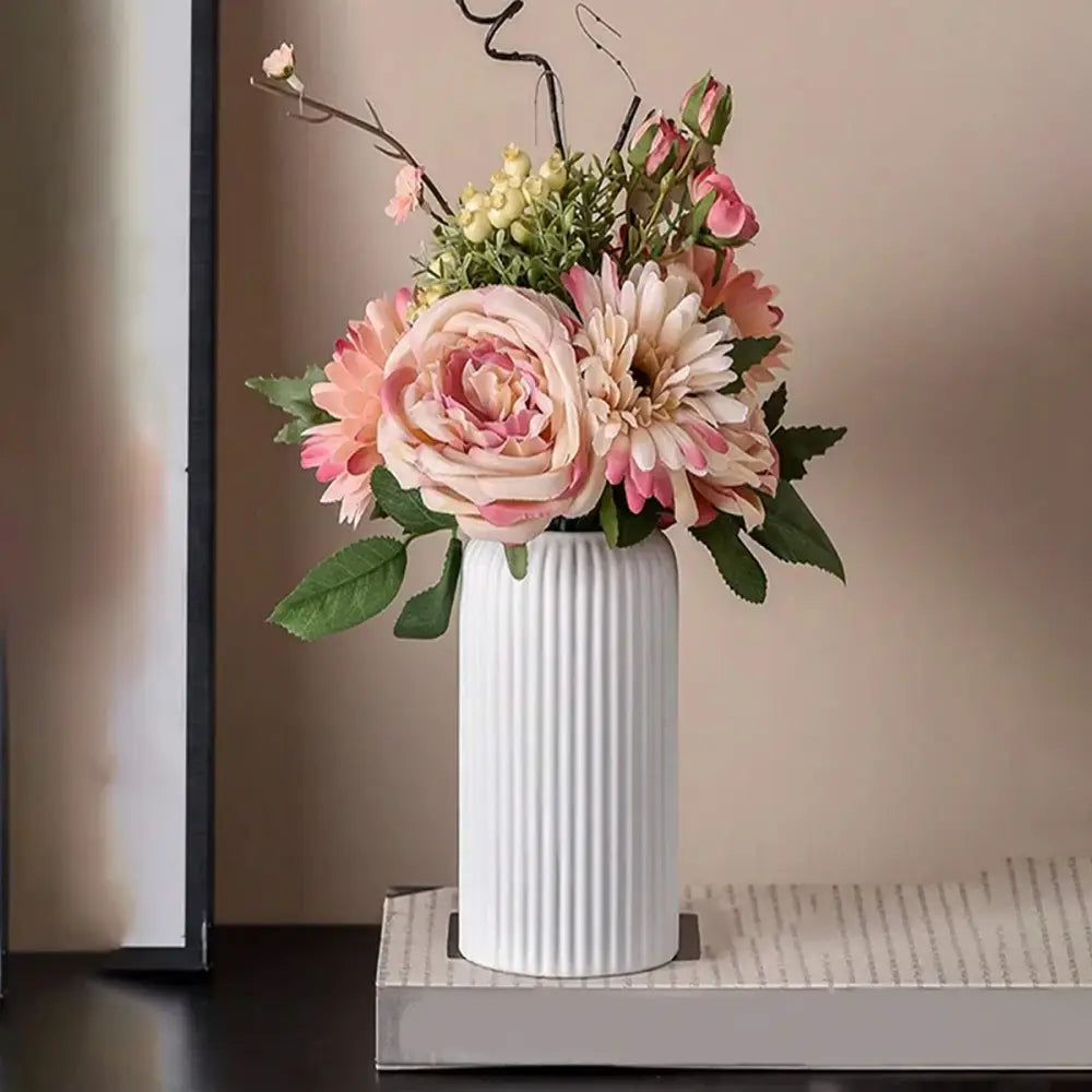 Decorbites™ striped ceramic-like plastic vase in white ribbed design holding pink and cream artificial flowers