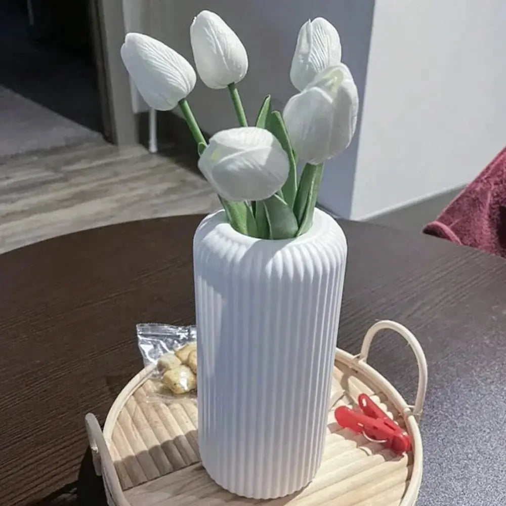 White ribbed striped ceramic-like plastic vase holding artificial white tulips from decorbites plastic vase collection