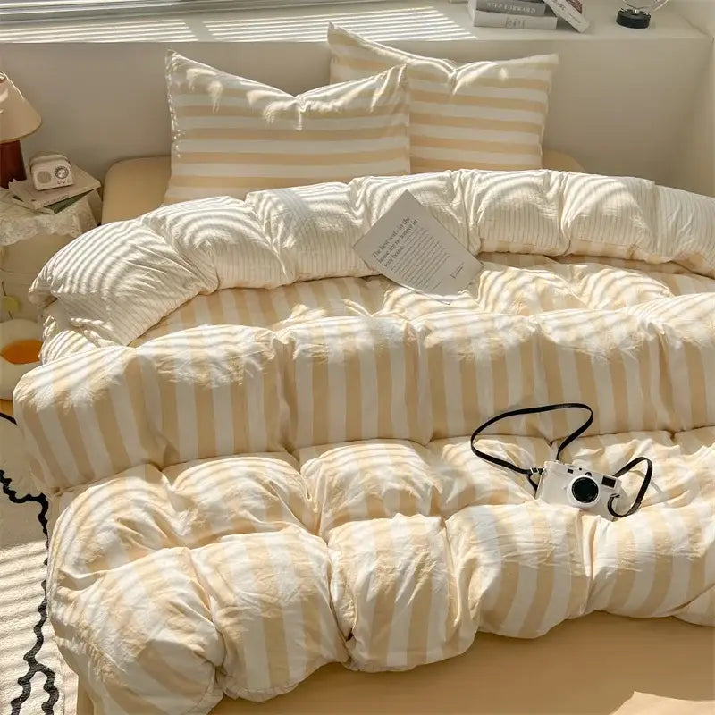 Cream and beige striped quilt set with pillowcases and bed sheet featuring a soft puffy texture by decorbites
