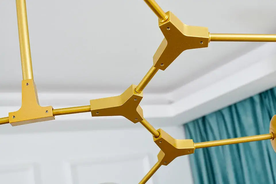 DecorBites stylish gold-colored geometric modern chandelier lighting with angular tripod connectors and cylindrical rods for dining and living rooms