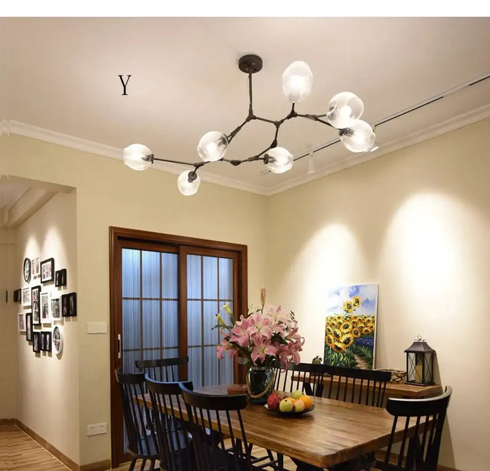 Modern chandelier lighting featuring a black metal frame with frosted glass globe bulbs for dining and living rooms