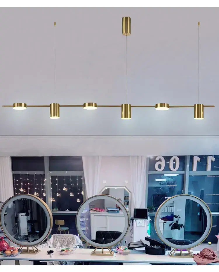 Gold-toned linear led chandelier with five cylindrical fixtures by DecorBites for stylish home decor lighting