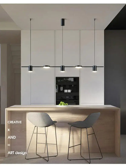 Modern black led chandelier with cylindrical shades ideal for stylish home decor above a minimalist kitchen island
