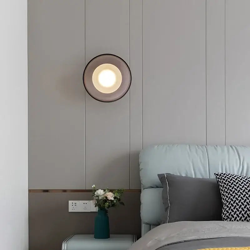 Decorbites™ stylish led wall lamp with circular dark metal frame and translucent glass shade emitting warm glow