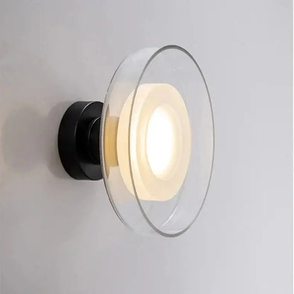 DecorBites™ stylish led wall lamp with black metal base and clear glass diffuser featuring concentric circular rings