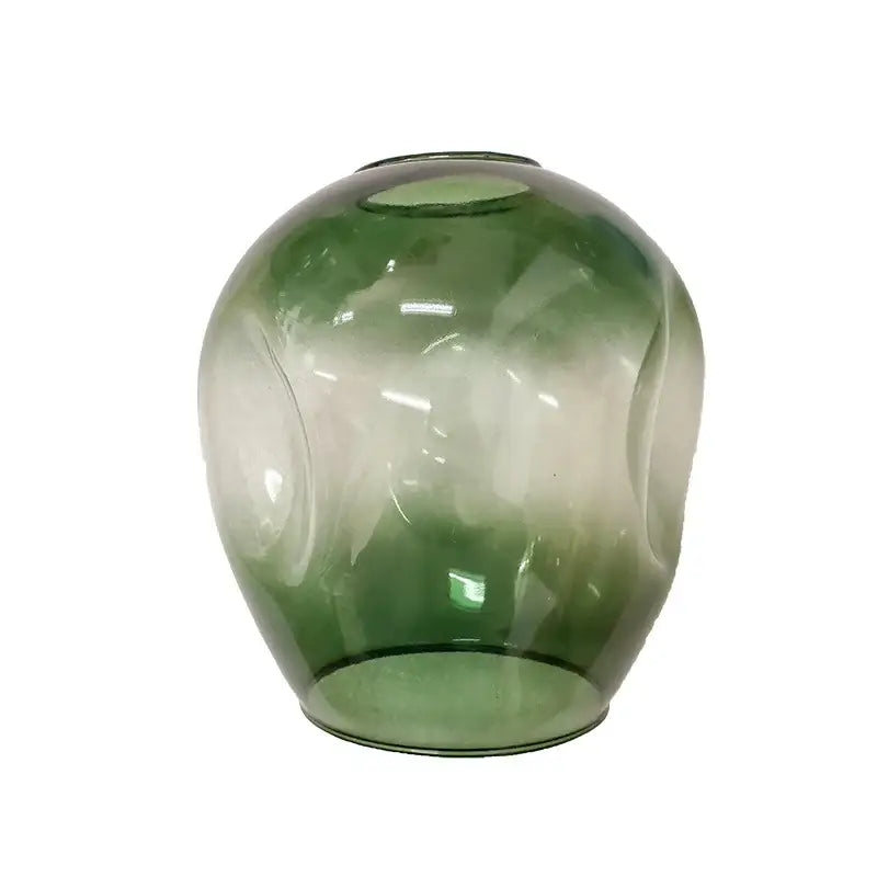 A translucent green glass vase with swirling patterns complements the stylish nordic chandelier for living rooms