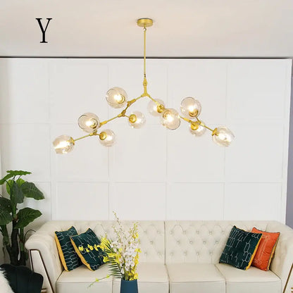 Gold-toned modern chandelier with multiple clear glass globes in a stylish nordic design for living room and dining