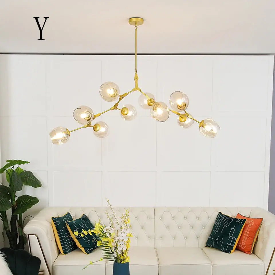 Gold-toned modern chandelier with multiple clear glass globes in a stylish nordic design for living room and dining