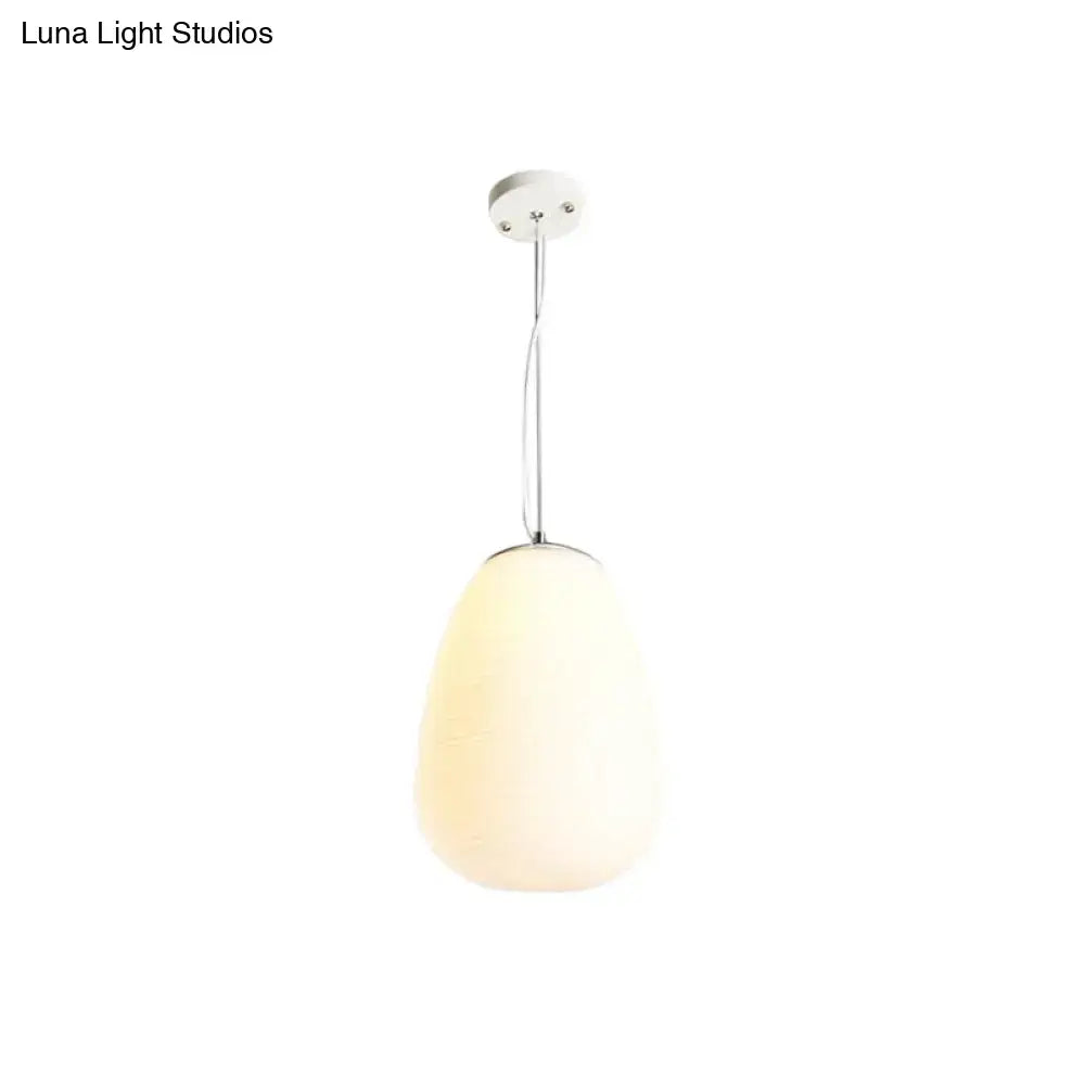 A sleek nordica pendant light with frosted opal glass shade and polished chrome, ideal for office and kitchen island lighting