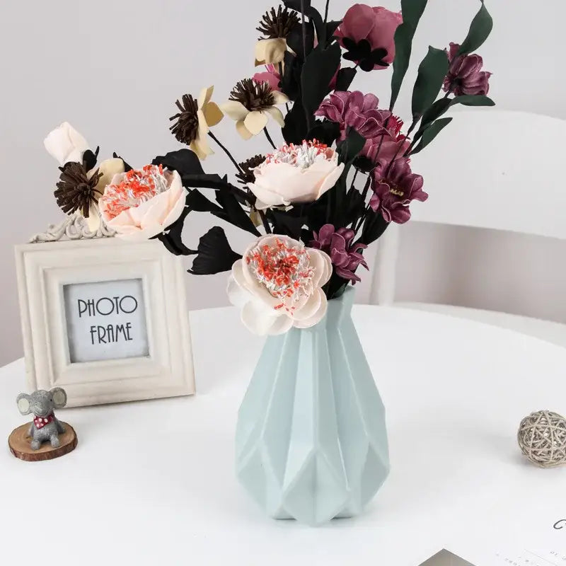 Decorbites™ stylish nordic light blue plastic flower vase with faceted design holding pink mauve and cream artificial flowers
