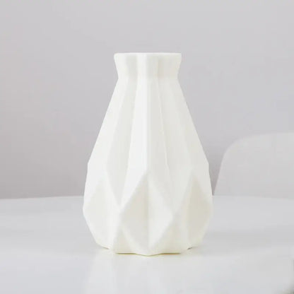 A sleek white ceramic flower vase with modern geometric facets and flared neck from decorbites plastic flower vase collection