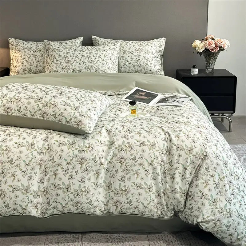 A soft cream-colored satin silk duvet cover set with a delicate gray floral pattern from DecorBites summer collection