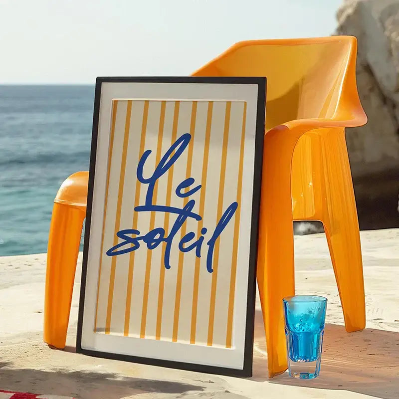 A sleek black framed DecorBites™ summer vibe beach canvas art print with vertical yellow stripes and blue cursive text on cream background