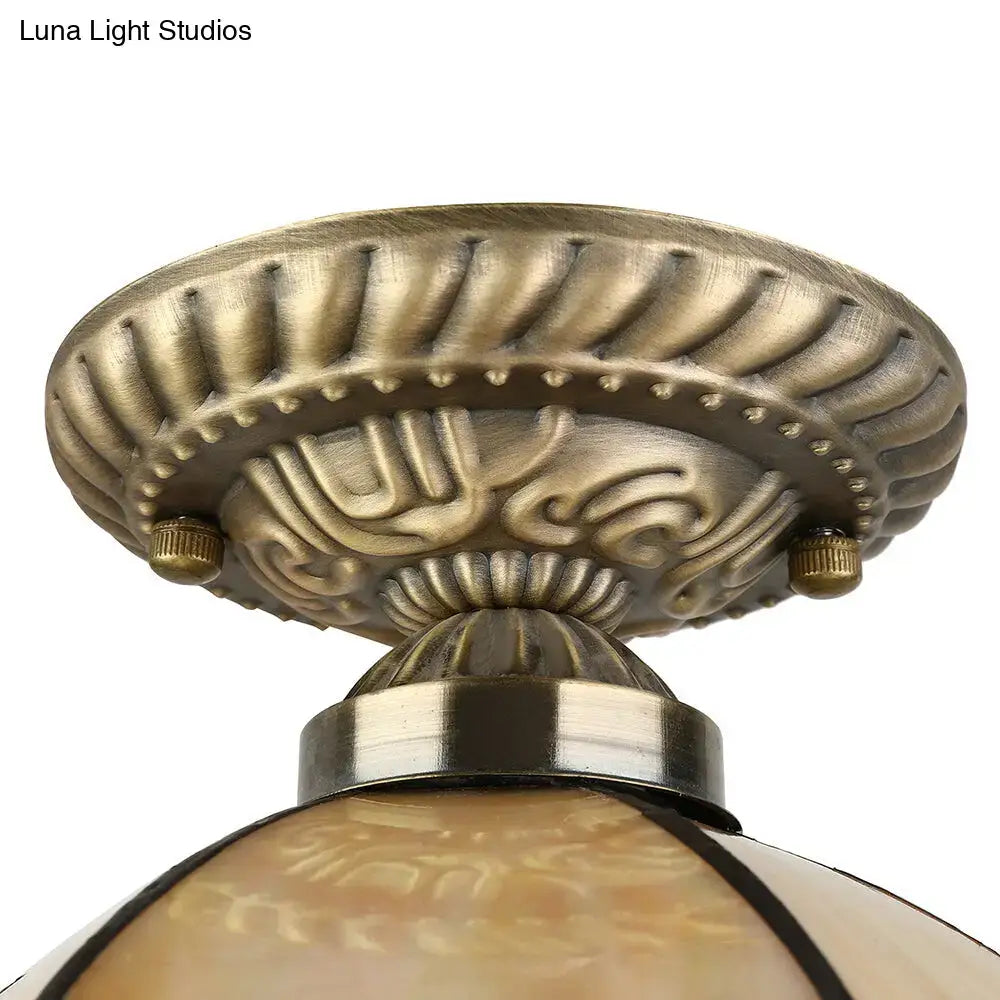 Antique brass-finished ceiling light with intricate scrollwork and beige domed glass shade for e27 light 220v-240v
