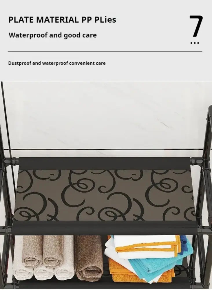 Black metal folding bathroom storage rack with gray fabric shelf and two levels holding rolled towels for toilet storage