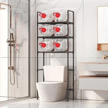 Black metal three-tier toilet storage rack by DecorBites™ holding clear water jugs with red caps for bathroom storage