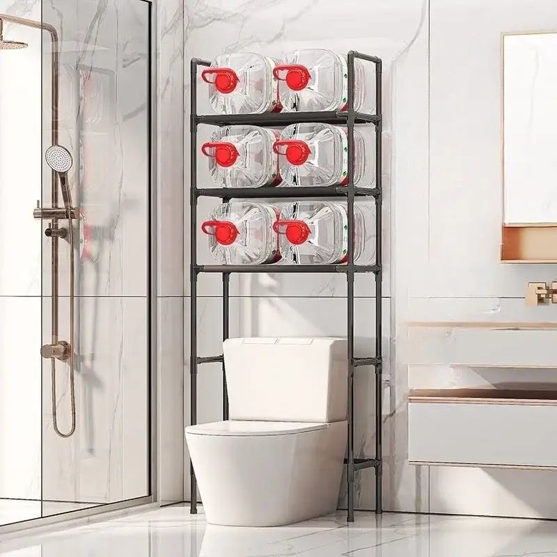 Black metal three-tier toilet storage rack by DecorBites™ holding clear water jugs with red caps for bathroom storage