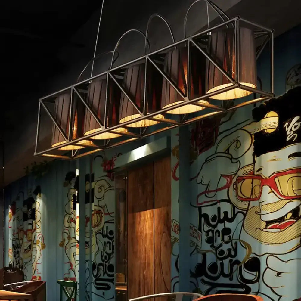 Industrial-style black fabric chandelier with five warm-toned lampshades ideal for island lighting and fixture height control
