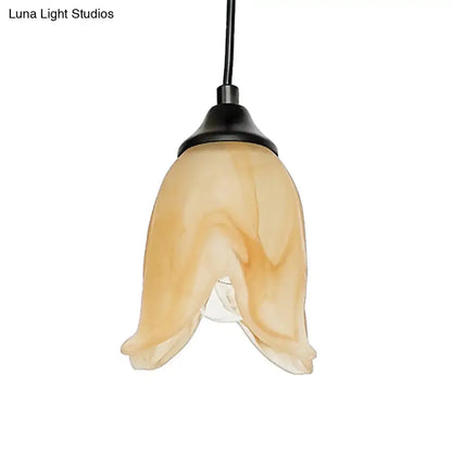 DecorBites traditional amber glass pendant light with flower cone shape and black metal fixture for living room use