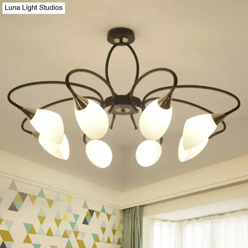 Black metal chandelier with six frosted oval white glass shades in a floral pattern for living room lighting