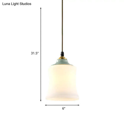 DecorBites traditional white glass pendant light with frosted glass, sage green ceramic top, and brass accents for restaurants