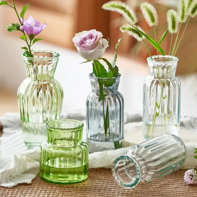 Clear glass transparent nordic vase with vertical ridged patterns and flared neck, one tipped on its side