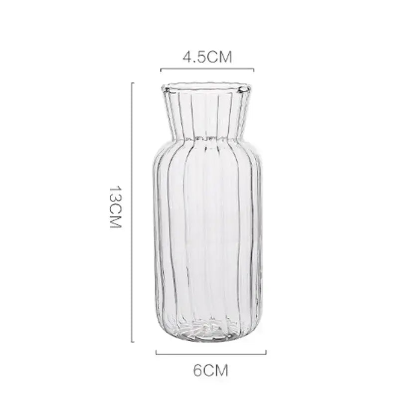 Clear glass transparent nordic vase with vertical ribbed texture and flared neck for plants and flowers by DecorBites