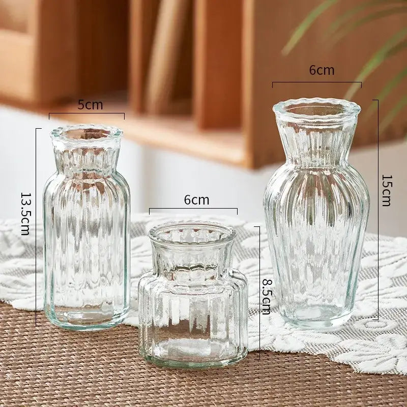 Three transparent nordic vases by decorbites with ribbed texture and fluted necks in varying heights of 5cm to 15cm