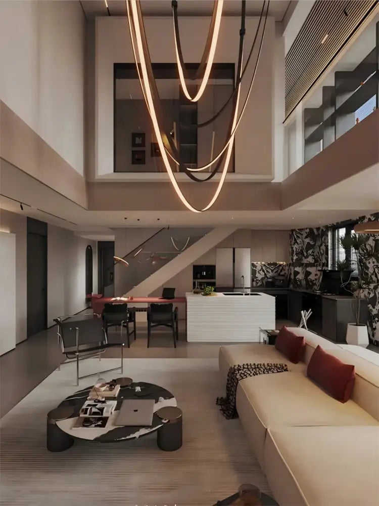 A modern minimalist coffee table with a black and white marble top and dark metal legs in a flexible leather belt chandelier setting