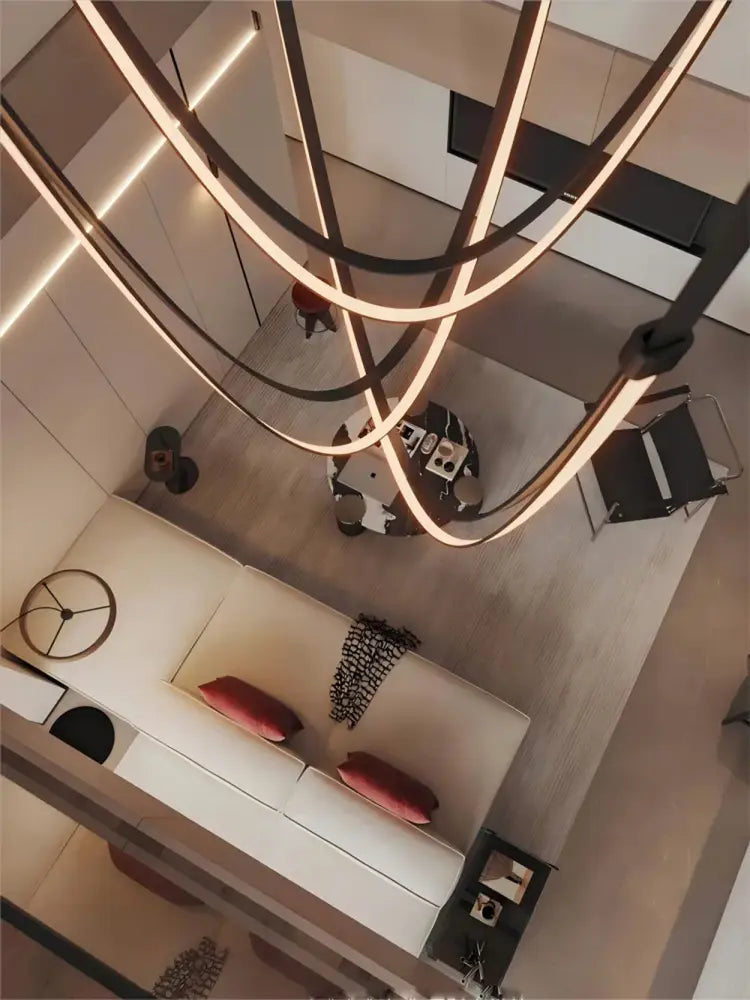 Modern minimalist decorbites™ led chandelier with sleek curved metallic arms and flexible leather belt accents in warm light