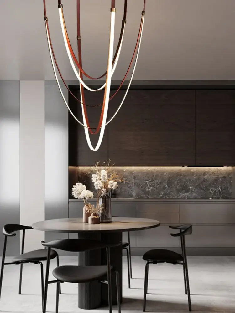 A modern DecorBites™ LED chandelier with flexible leather belt curved bands in white and brown leather-like material