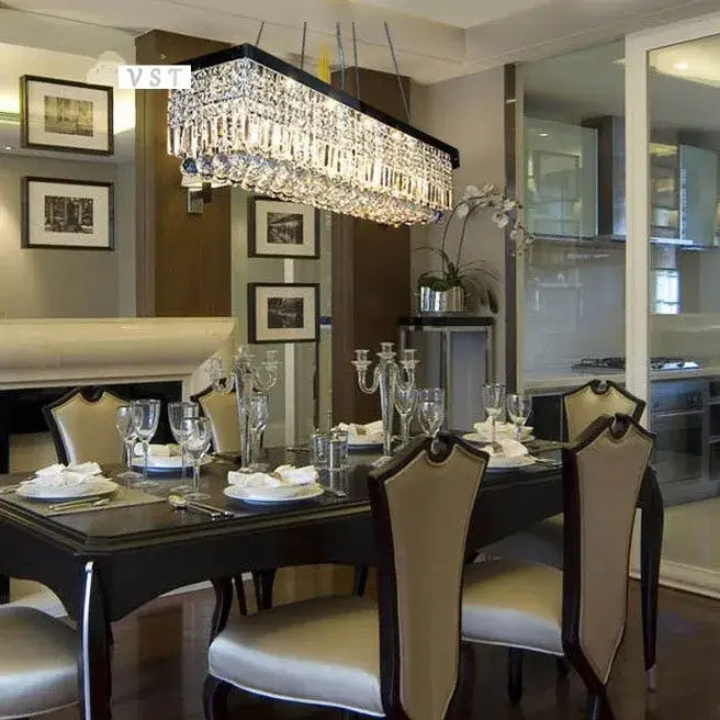 DecorBites upscale modern crystal chandelier with black frame hangs above dining table in dining room setting