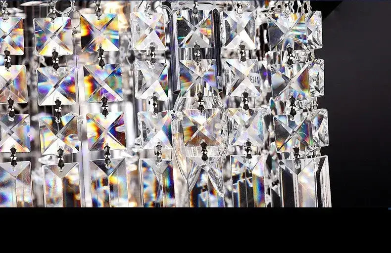 DecorBites upscale modern crystal chandelier with clear faceted glass prisms refracting light for dining room use