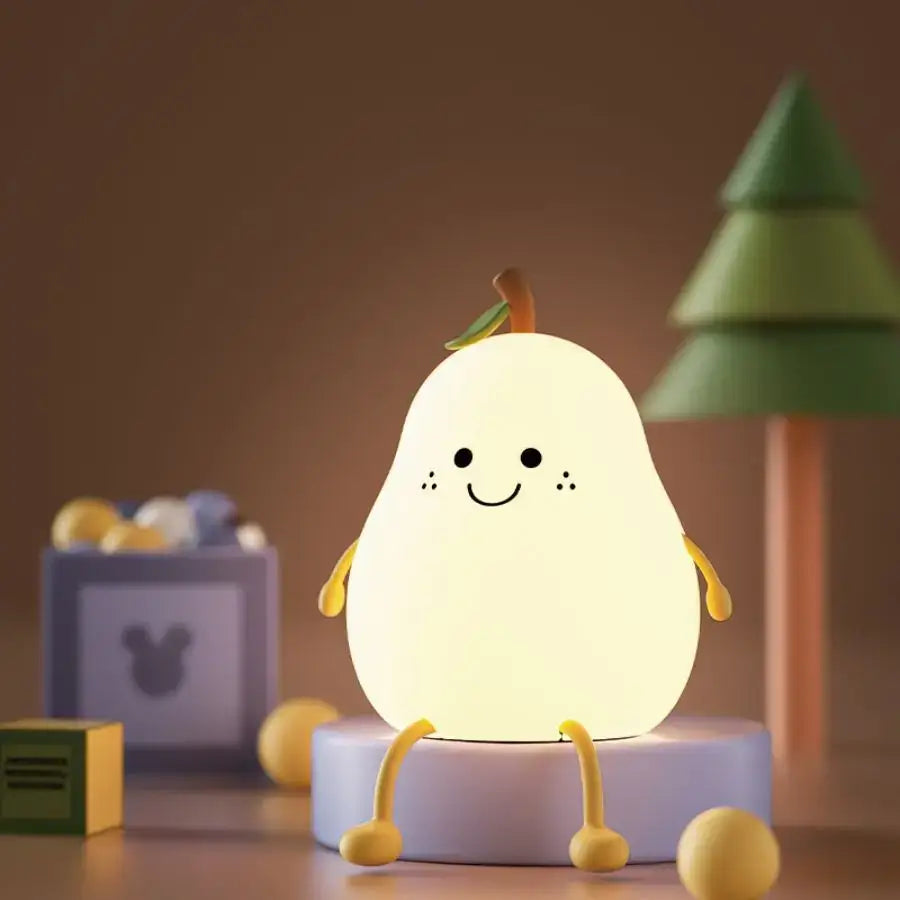 A soft glowing pear-shaped silicone night light with a smiling face and yellow limbs rechargeable night light