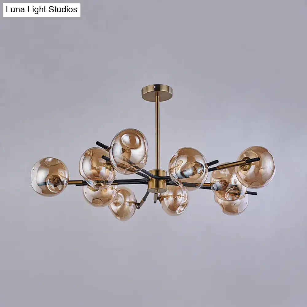 Modern brass-finished flush mount chandelier with amber-tinted glass globes for elegant living room lighting