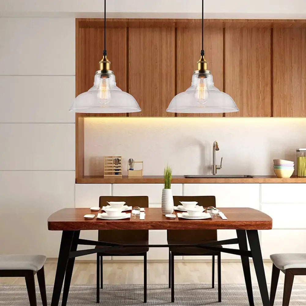 Two DecorBites vintage chrome pendant lights with clear glass and brass accents hang above wooden dining table