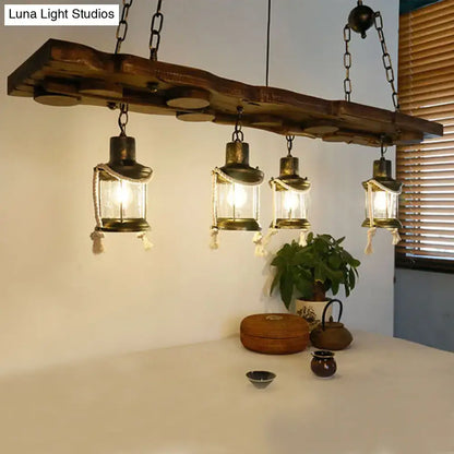 Rustic dark wood island lamp with four brass lantern lights hanging from chains in a vintage kerosene chandelier design