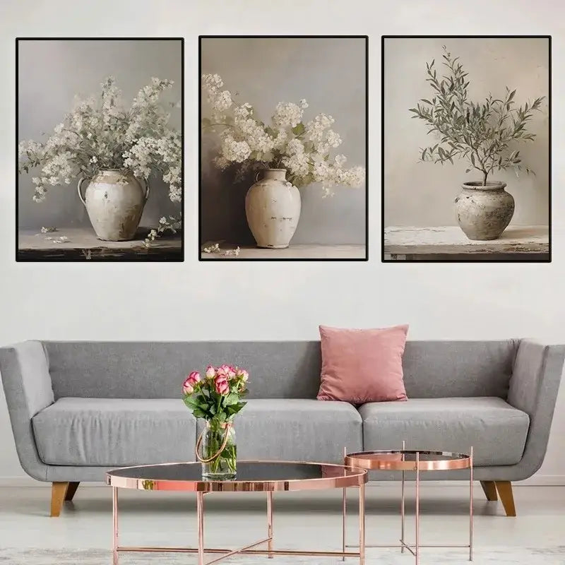 Set of three framed DecorBites™ vintage floral vase canvas wall art prints featuring rustic ceramic vases with white and green flowers