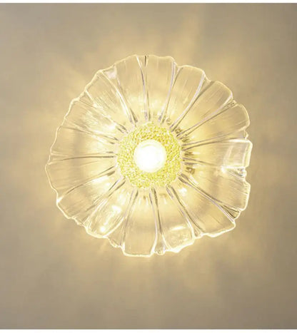 Clear glass ceiling pendant light with petal-like design and central yellow-green textured flower glass accent for home decor