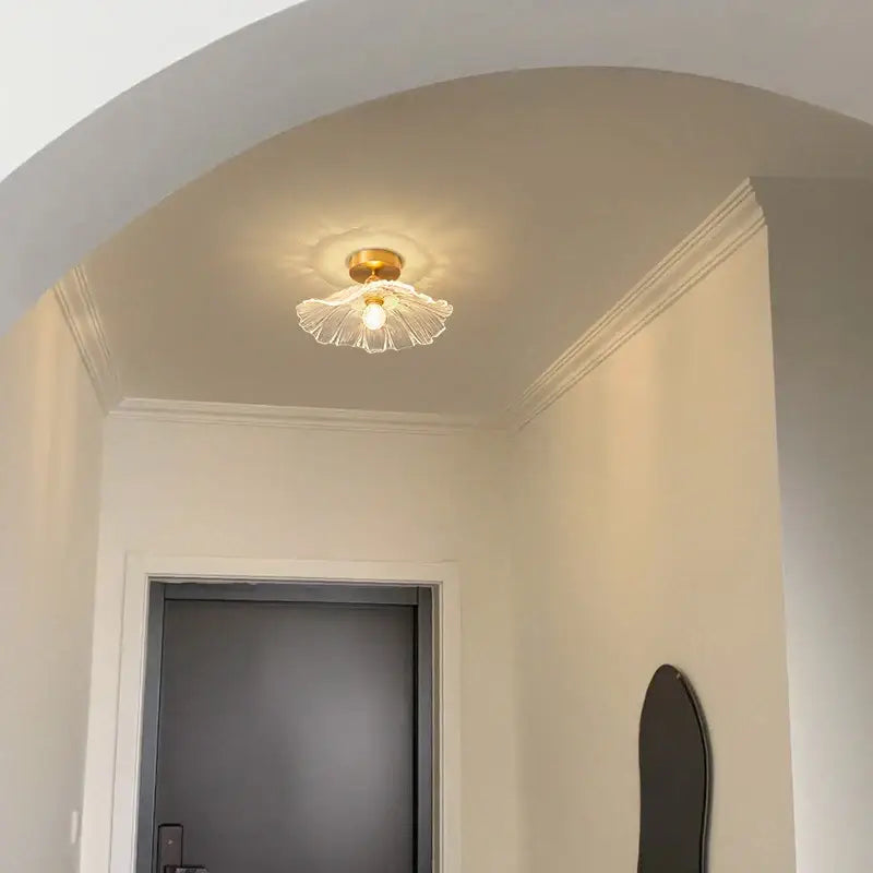 A delicate translucent flower glass pendant light with a golden base for vintage home decor by decorbites