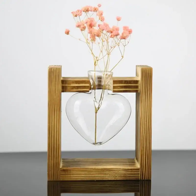 DecorBites™ vintage heart-shaped glass vase with pink dried flowers nestled in a wooden frame glass display
