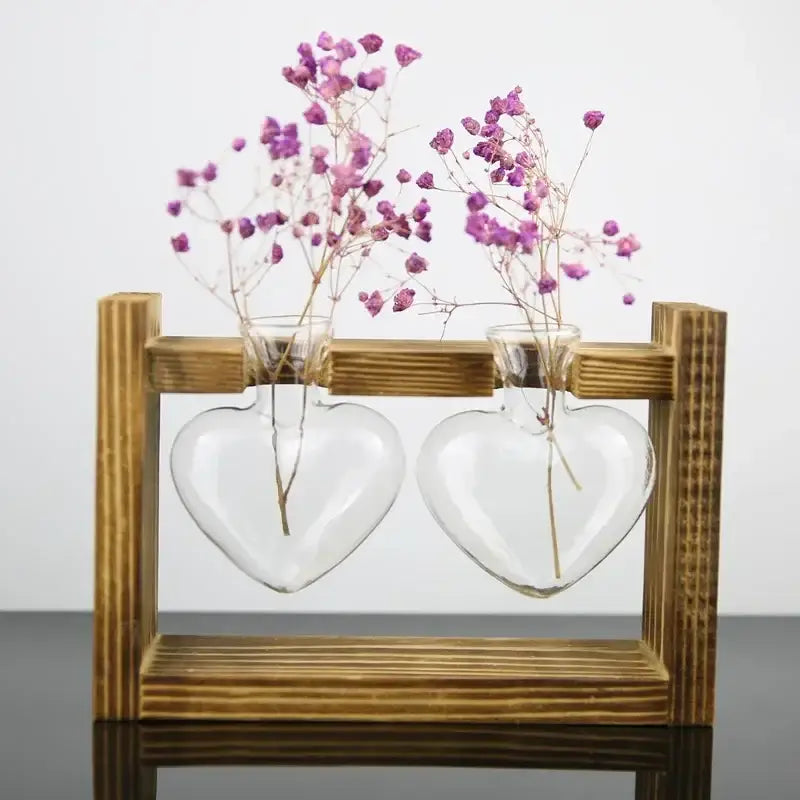 DecorBites™ vintage heart-shaped glass vase with wooden frame holding delicate purple dried flowers