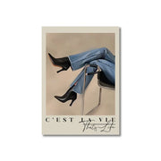 Black leather high-heeled ankle boots paired with light blue denim jeans complement decorbites™ vintage pink cartoon print wall art